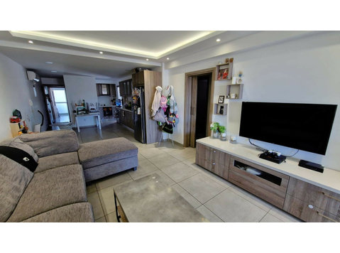 Located on the top floor of a three-story building in a… - Houses