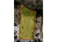 Half share of land located in a quiet area at Kissonerga,… - Mājas