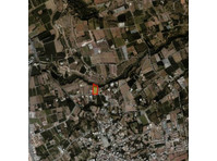 Half share of land located in a quiet area at Kissonerga,… - Casas