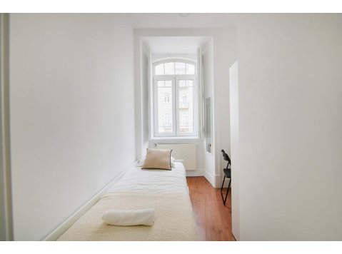 Bedroom in a 9-Bedroom Apartment in Rua Morais Soares,… - Apartments