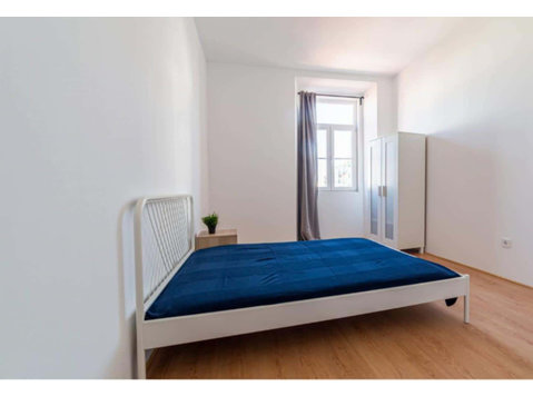 Quarto com cama de casal em apartamento com 9 quartos -… - Apartments